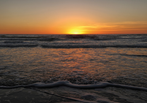 sunset over south padre island shore