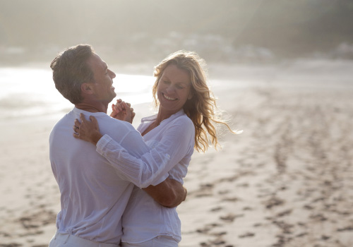 Adult couple dancing on beach