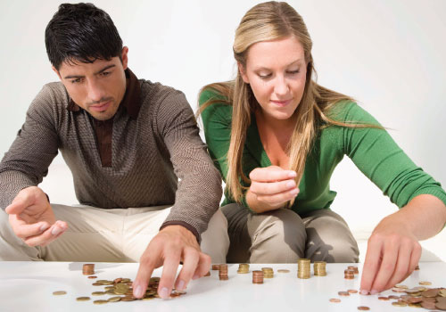 young adult male and female couple working together to count change